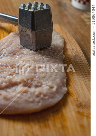 pounding a fillet with a hammer for a diet lunch 119864044