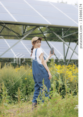 A woman standing in front of a solar panel A woman standing in front of a solar panel 119866174