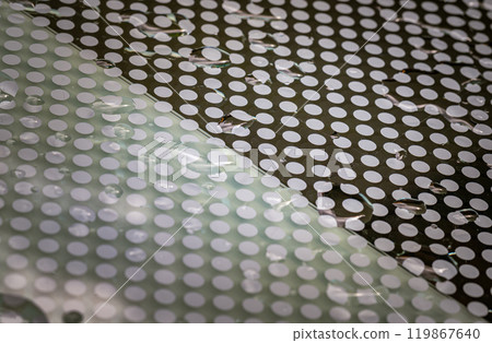 Rain water drops on a Glass floor. Detail of Water droplets caused by rain perched on surface of the Glass. 119867640