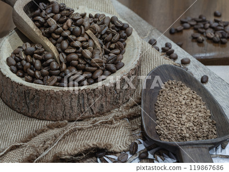 Coffee beans in scoop on round wooden bowl and Instant coffee in wooden spoon. Coffee beans in scoop on round wooden bowl and Instant coffee in wooden spoon. 119867686