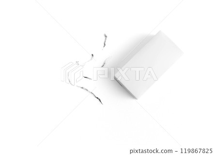 White eraser on a white surface with a few eraser shavings scattered around, emphasizing simplicity and cleanliness. 119867825