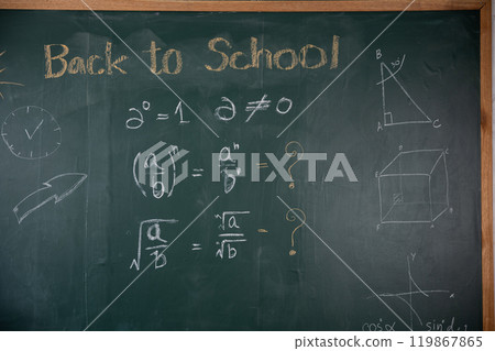 A chalkboard with math problems and the words back to school written on it. The chalkboard is green and has a clock on the left side A chalkboard with math problems and the words back to school written on it. The chalkboard is green and has a clock on the left side 119867865