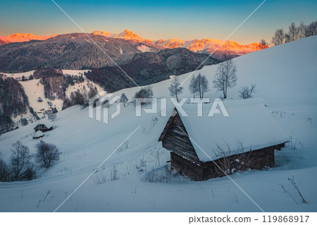 Winter scenery with snowy hut on the hill at sunset Winter scenery with snowy hut on the hill at sunset 119868917