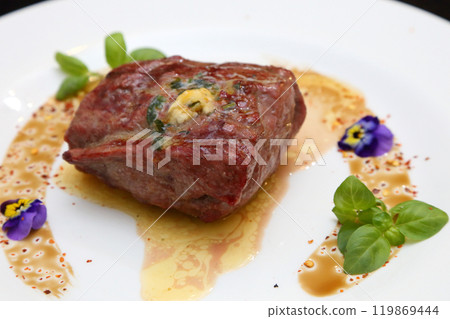 Steak on a white plate. The perfect beef steak. Medium rare steak, beautifully served on a white plate. 119869444