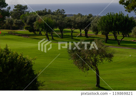A serene afternoon at the golf course overlooking the tranquil ocean under a clear sky A serene afternoon at the golf course overlooking the tranquil ocean under a clear sky 119869821