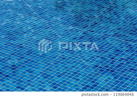 Bright blue mosaic tiles covering a refreshing swimming pool under the sunlight on a warm summer day Bright blue mosaic tiles covering a refreshing swimming pool under the sunlight on a warm summer day 119869848