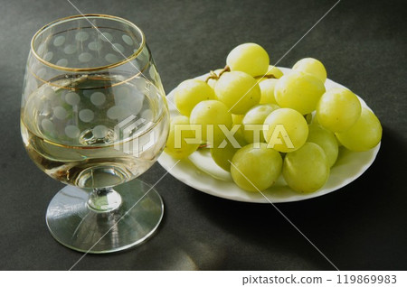 White wine and grapes in a glass 119869983