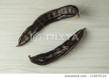 Carob carob fruit and seeds on white background Carob carob fruit and seeds on white background 119870124