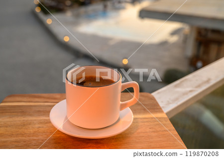 Black coffee in a mug on the background of the pool 119870208