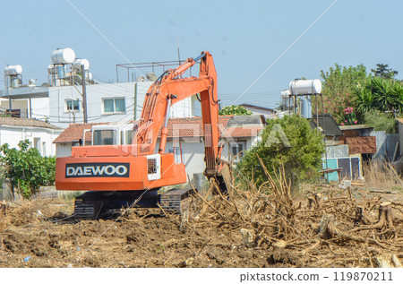 Gazeveren Cyprus 03.07.2024 - excavator uproots the roots of orange trees 119870211