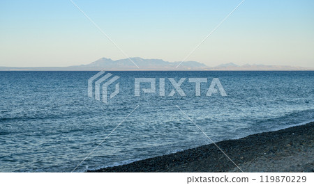Image shows a deserted beach at sunset 119870229