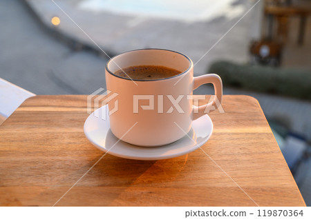 Black coffee in a mug on the background of the pool Black coffee in a mug on the background of the pool 119870364
