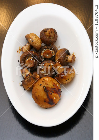 Fried champignons on a white oval plate. Fried champignons on a white oval plate. 119870412