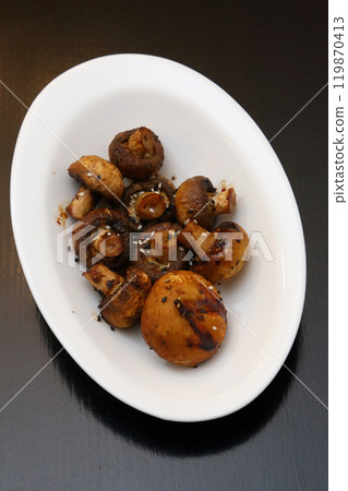 Fried champignons on a white oval plate. Fried champignons on a white oval plate. 119870413