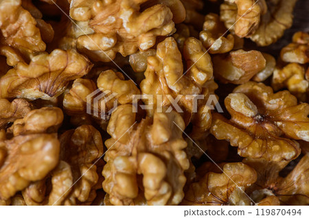 Many tasty walnuts as background, top view closeup of shelled organic walnut halves 119870494