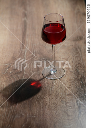wine in a glass on a wooden table wine in a glass on a wooden table 119870626