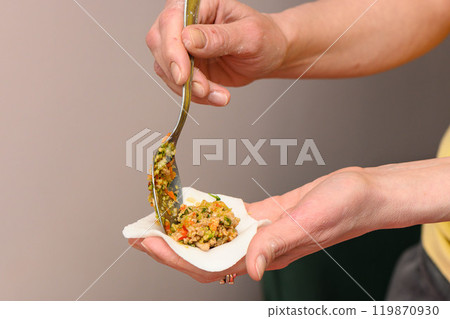 Hand molding. Dough with meat. Woman sculpt dumplings with her hands. Hand molding. Dough with meat. Woman sculpt dumplings with her hands. 119870930