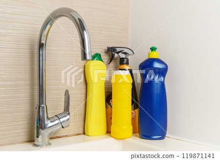 Cleaning product plastic container for house clean on wooden table and blue background . household chemicals 119871141