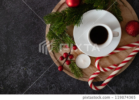 Santa's special delivery: Top-view shot of chic gift boxes, adorned with green bows, gold and green ornaments, star decorations, confetti on black backdrop, space for your festive wishes or promo 119874365