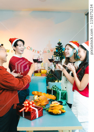 Dinner and group of people celebrating together at Merry Christmas and Happy New Year. 119875234