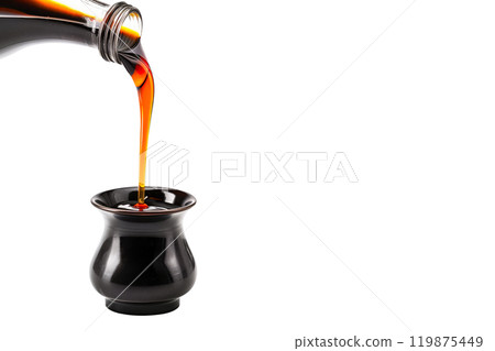 Dark soy sauce poured from bottle isolated on white transparent background. 119875449
