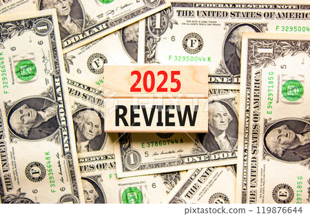 Planning 2025 review new year symbol. Concept words 2025 Review on beautiful wooden blocks. Dollar bills. Beautiful background from dollar bills. Business 2025 review new year concept. Copy space. Planning 2025 review new year symbol. Concept words 2025 Review on beautiful wooden blocks. Dollar bills. Beautiful background from dollar bills. Business 2025 review new year concept. Copy space. 119876644