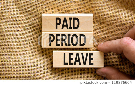 Paid period leave symbol. Concept words Paid period leave on wooden blocks. Beautiful canvas table canvas background. Doctor hand. Business medical paid period leave concept. Copy space. 119876664