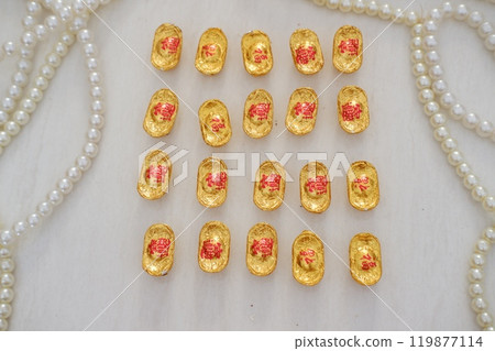 gold chocolate coins on white surface, symbolizing wealth and prosperity gold chocolate coins on white surface, symbolizing wealth and prosperity 119877114