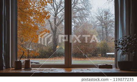 View from inside to outside with fall rainy day outside window of country house. Rural home in autumnal season. Wet window surface with rain drops. This is AI-generated item 119877235