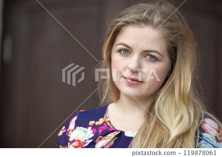 Portrait of a blonde girl with blue eyes. A girl with a European style face. Portrait of a blonde girl with blue eyes. A girl with a European style face. 119878061