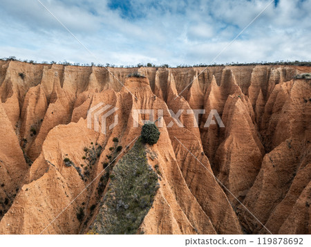 red sand and clay mountains Las Carcavas by Madrid, eroded badlands formation and desert landscape, aerial top view 119878692