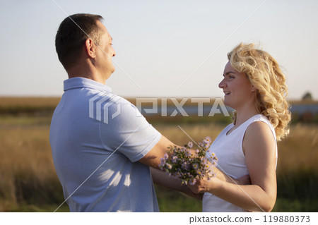Beautiful middle-aged couple in love on the background of nature. Husband and wife. Beautiful middle-aged couple in love on the background of nature. Husband and wife. 119880373