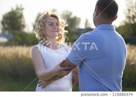 Beautiful middle-aged couple in love on the background of nature. Husband and wife. Beautiful middle-aged couple in love on the background of nature. Husband and wife. 119880374