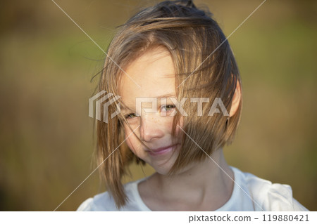 Portrait of five six-year-old girls against the background of nature. 119880421