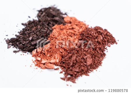 Scattered eye shadows in different shades. Cosmetics texture, white background. Scattered eye shadows in different shades. Cosmetics texture, white background. 119880578