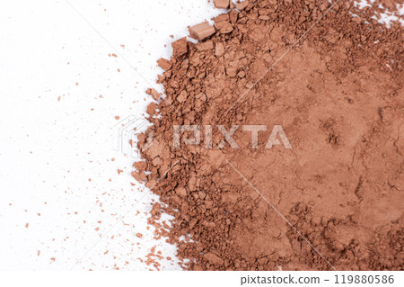 Scattered brown eyeshadow on a white background. Eye shadow texture 119880586