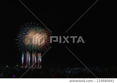 People watching colorful fireworks at the Sagara Marine Fireworks Festival at Sagara Sun Beach in Makinohara City (Shizuoka Prefecture) 119880842