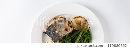 Enjoy a delicious and nutritious meal of baked green beans with onions and baked mackerel, beautifully presented on a plate against a white background, perfect for dinner, banner Enjoy a delicious and nutritious meal of baked green beans with onions and baked mackerel, beautifully presented on a plate against a white background, perfect for dinner, banner 119880862