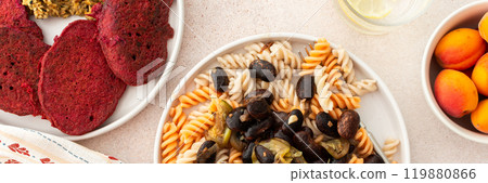 Savor gluten-free pasta with baked beans and zucchini, alongside beet pancakes with sunflower seed hummus 119880866