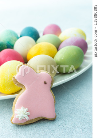 Multi-colored Easter eggs in an oval dish on a blue background, Happy Easter holiday Multi-colored Easter eggs in an oval dish on a blue background, Happy Easter holiday 119880895