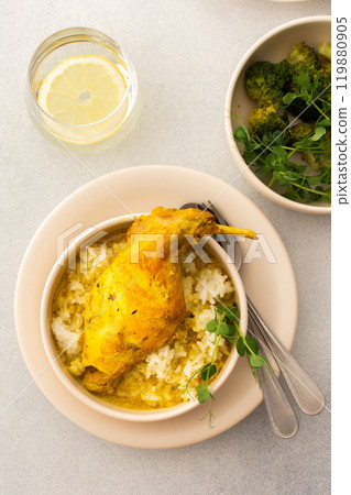 Stewed rabbit with rice, broccoli , served table with food Stewed rabbit with rice, broccoli , served table with food 119880905