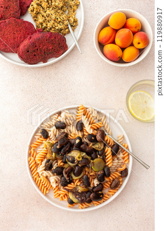 Gluten-free pasta with baked beans and zucchini, paired with beet pancakes topped with sunflower seed hummus Gluten-free pasta with baked beans and zucchini, paired with beet pancakes topped with sunflower seed hummus 119880917
