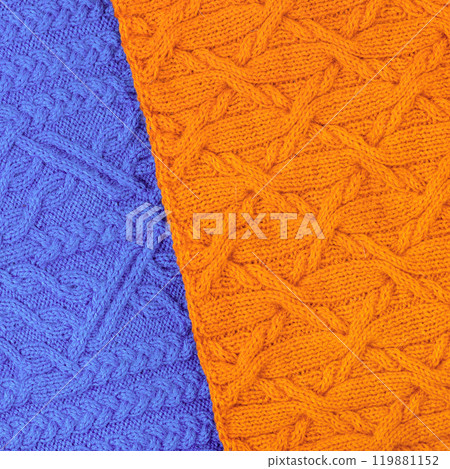 Abstract knitted two-tone background in blue and orange. Large knitted fabric with a pattern. Close-up of knitted blanket. Copy space 119881152