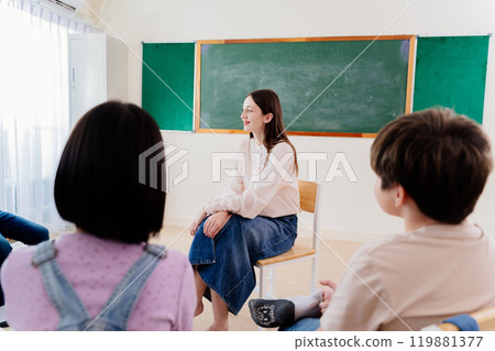 Friendly Teacher Facilitates Interactive Learning Circle with Young Pupils, Nurturing Communication Skills in School 119881377