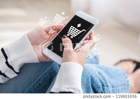 A woman shopping online on a smartphone A woman shopping online on a smartphone 119881656