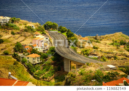 An expressway running along the ocean in a picturesque area among the buildings An expressway running along the ocean in a picturesque area among the buildings 119882549