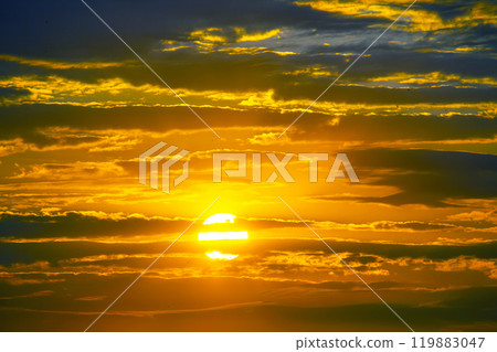 evening sky after sunset showcases a mesmerizing blend of deep blues and fiery oranges 119883047