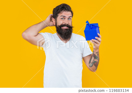 birthday shopping of confused man isolated on yellow background. man on birthday shopping. birthday shopping of confused man isolated on yellow background. man on birthday shopping. 119883134