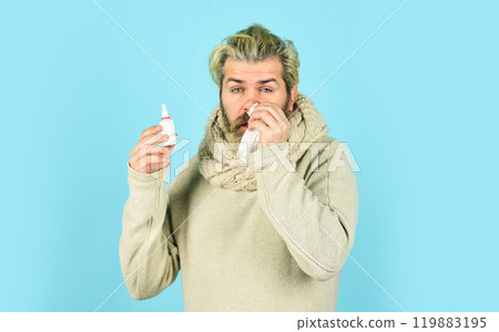 Runny nose and other symptoms of cold. coronavirus from china. man use effective medicines. man hold nasal drops. It helps. Flu concept. hipster feels badly ill sneezing. Effective nasal spray 119883195