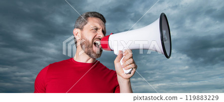 man in red shirt scream in loudspeaker on sky background man in red shirt scream in loudspeaker on sky background 119883229